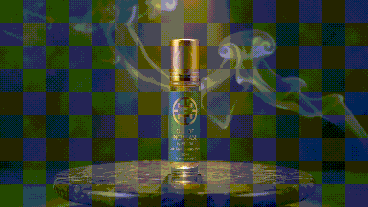 The Oil of Increase rotating in warm light with incense smoke