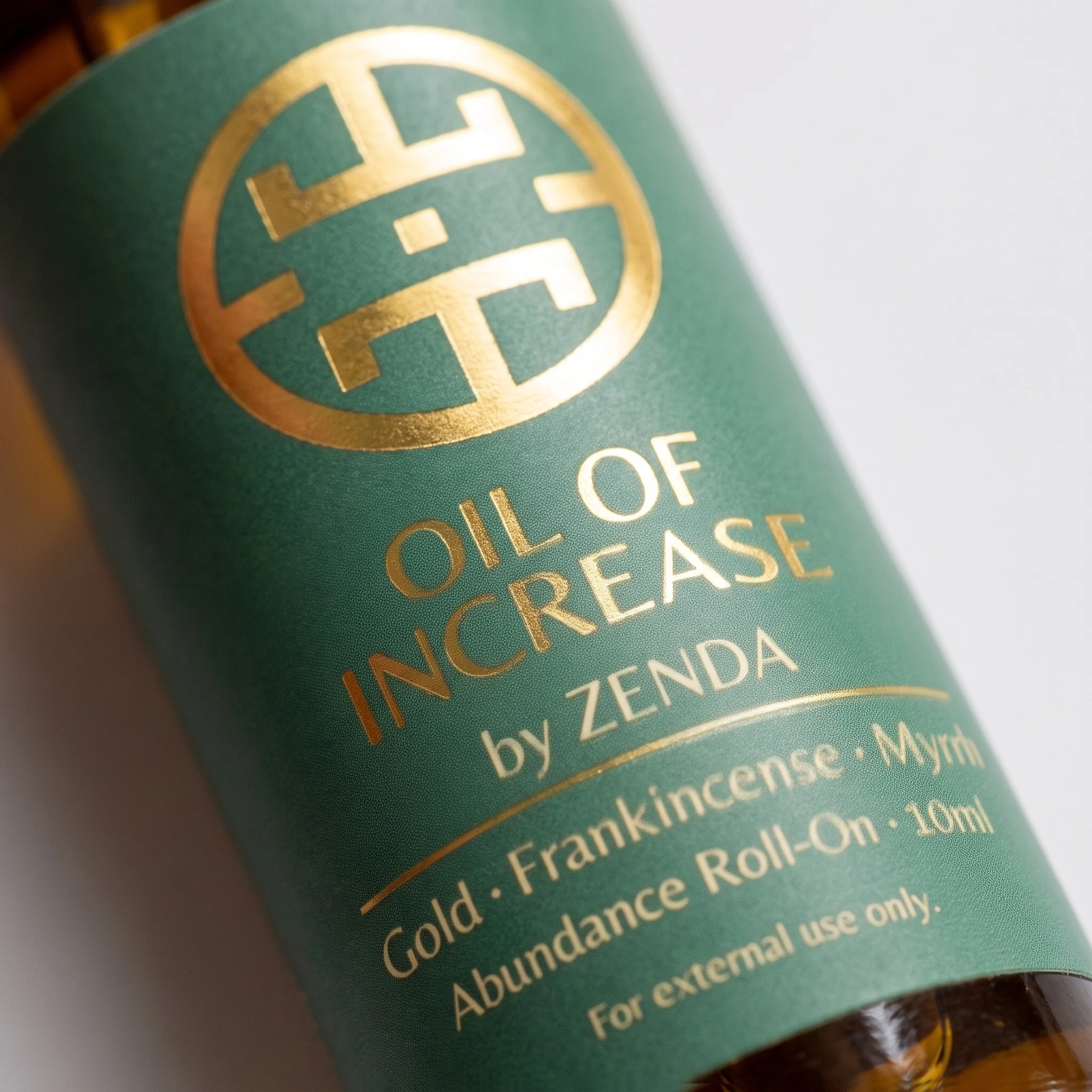 Gold foil label close-up: Oil of Increase by Zenda, gold, frankincense, myrrh